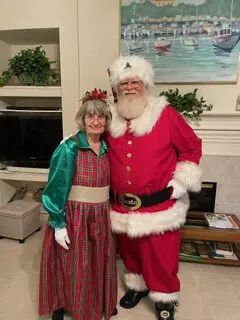 A man and woman dressed up as santa clause