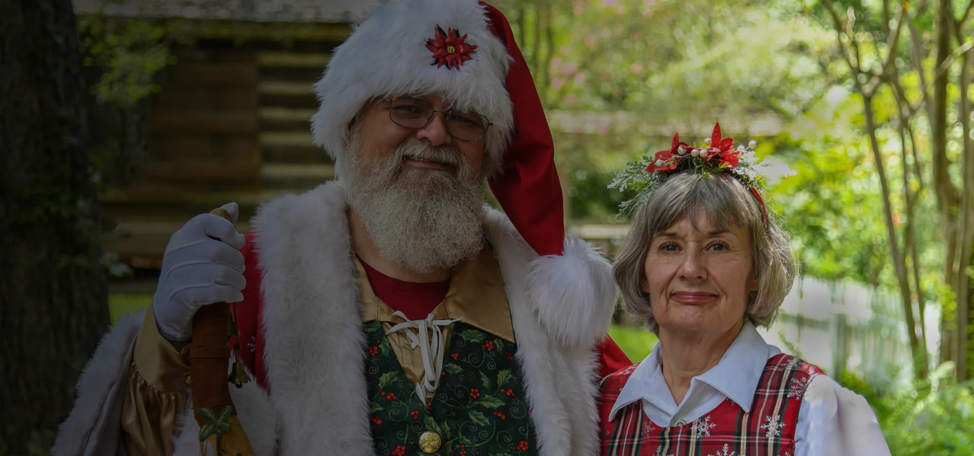 A man and woman dressed as santa clause.